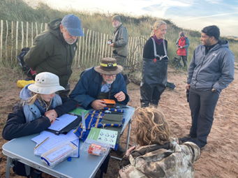 The processing team taking the time to teach new members about processing waders